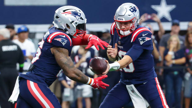 New England Patriots quarterback Mac Jones (10) and running back Ezekiel Elliott (15) warm up before the game against the Dallas Cowboys at AT&T Stadium.
